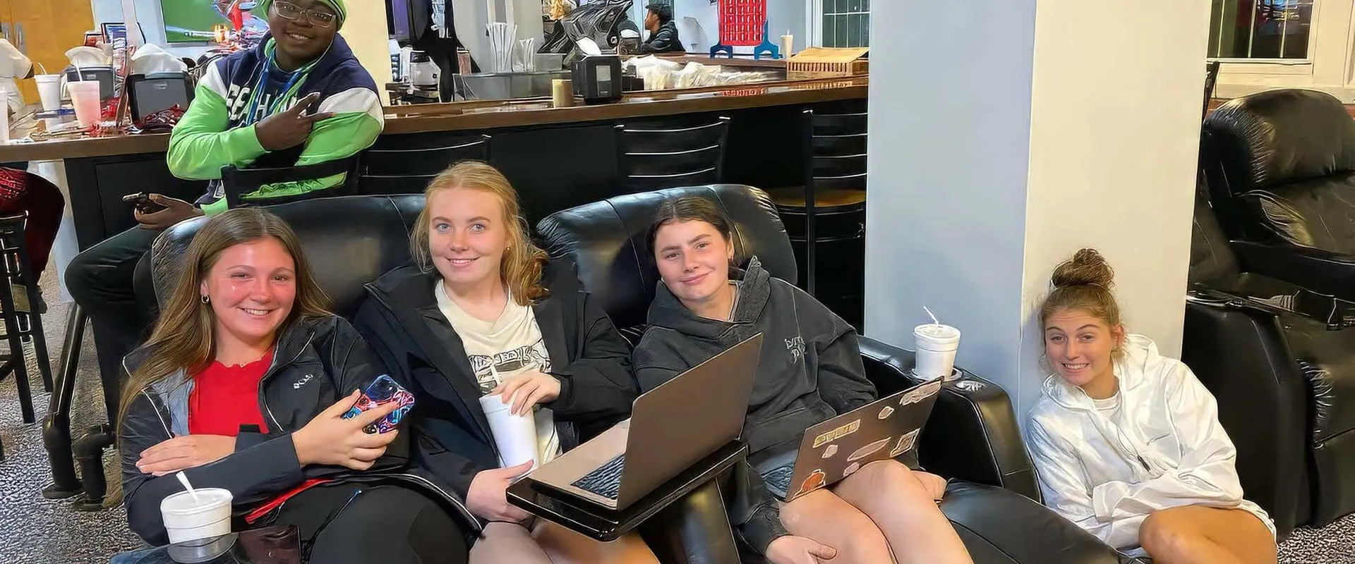 Students in Wolf Den watching a football game