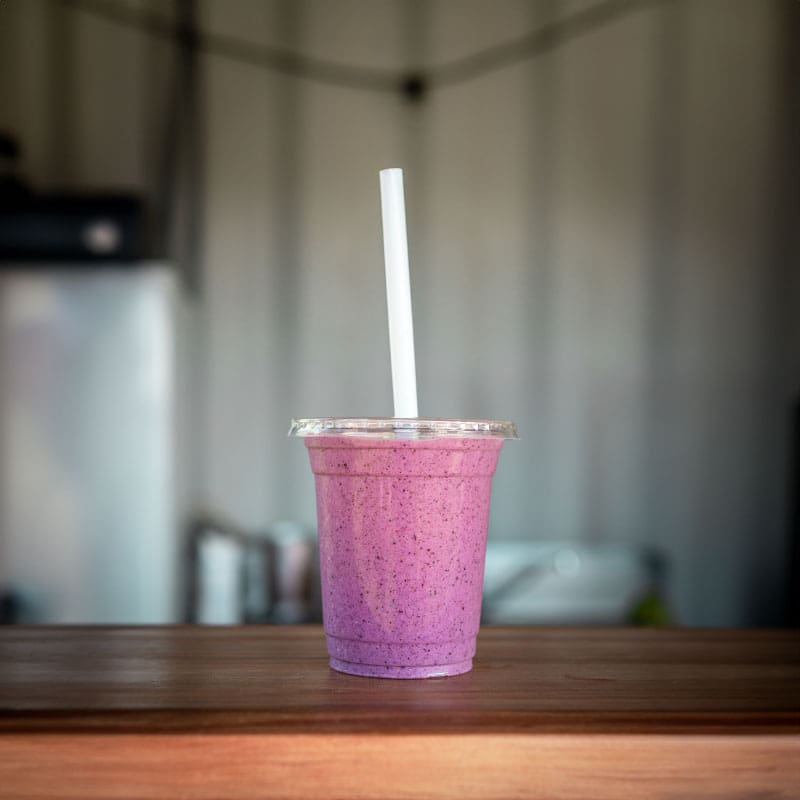Cup of smoothie on table